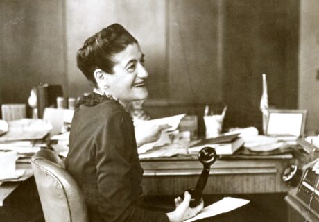 Image of Auerbach sitting at her office desk